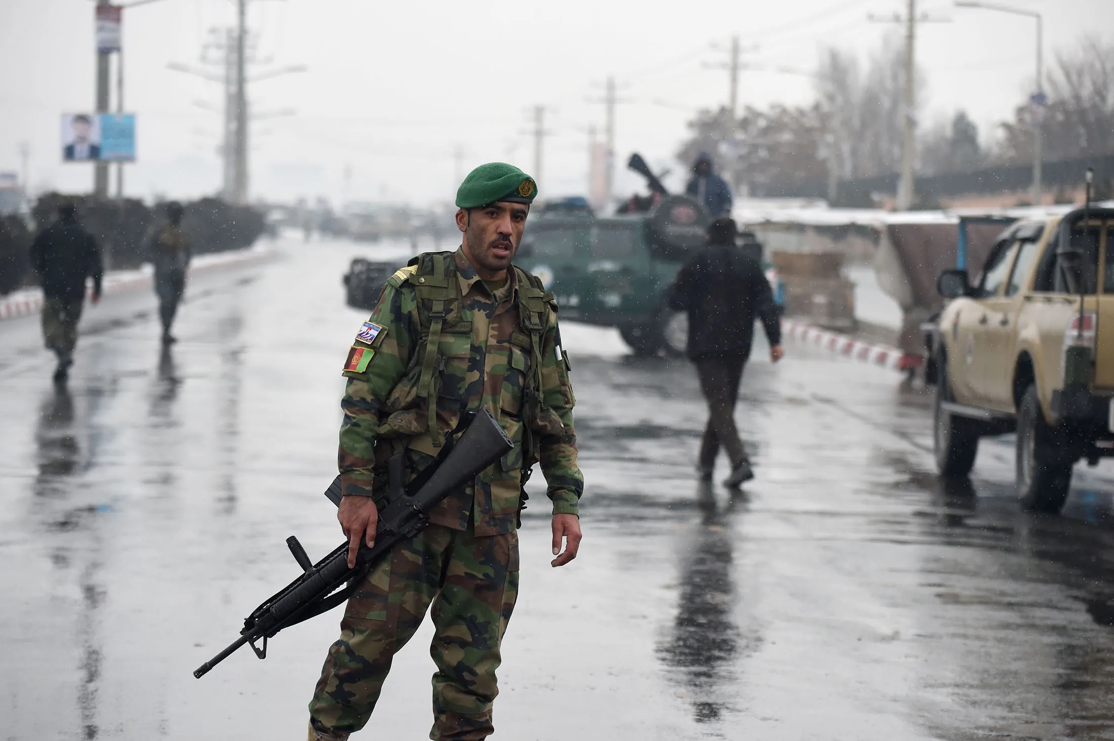 Afghan security personnel stand guard near the site of an attack near the Marshal Fahim Military Academy base in Kabul on January 29, 2018
