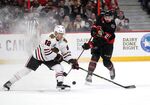 Ottawa Senators left wing Nick Paul (21) takes a shot past Chicago Blackhawks defenseman Caleb Jones (82) to score on goaltender Marc-Andre Fleury (29), not shown, during the second period of an NHL hockey game Saturday, March 12, 2022 in Ottawa, Ontario.(Justin Tang/The Canadian Press via AP)