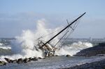 Waves crash against a sailboat in Elsinore, Denmark, on Jan. 30.