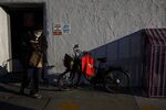 A DoorDash Inc. bag hangs on a bicycle as a food delivery courier picks up an order from a restaurant in Los Angeles, California on July 6.