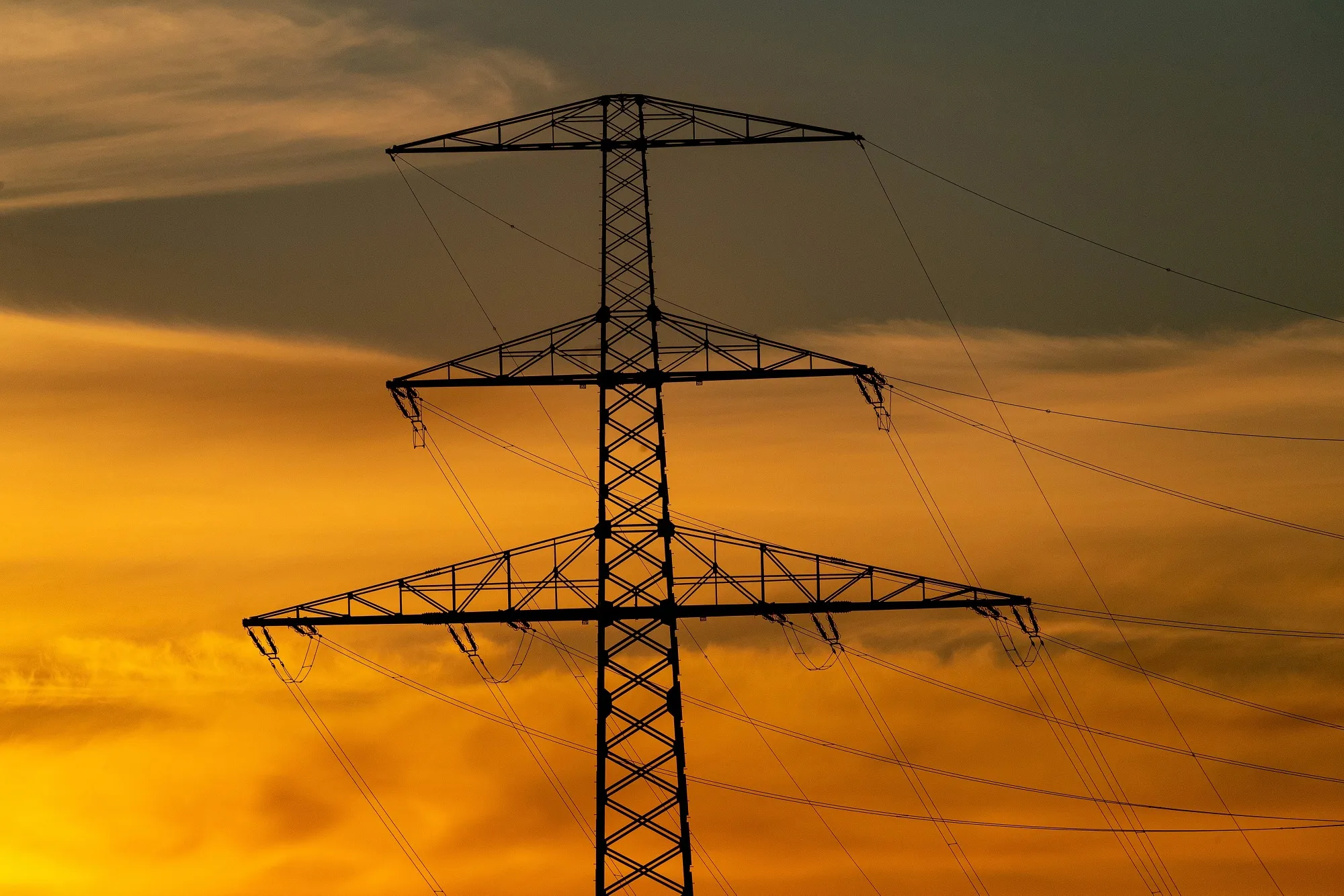 An Electricity Pylon And Power Lines At Sunset