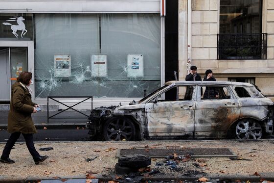 Macron Blinks as Yellow-Vests Protest Forces Fuel-Tax Climbdown