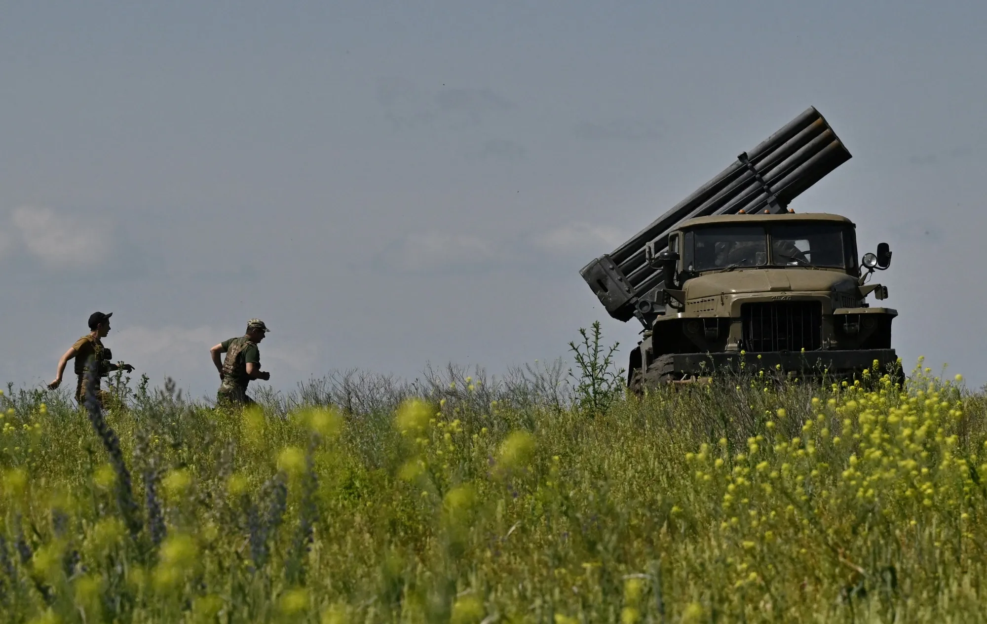 Ukrainian servicemen prepare to fire a multiple rocket launcher near Bakhmut.