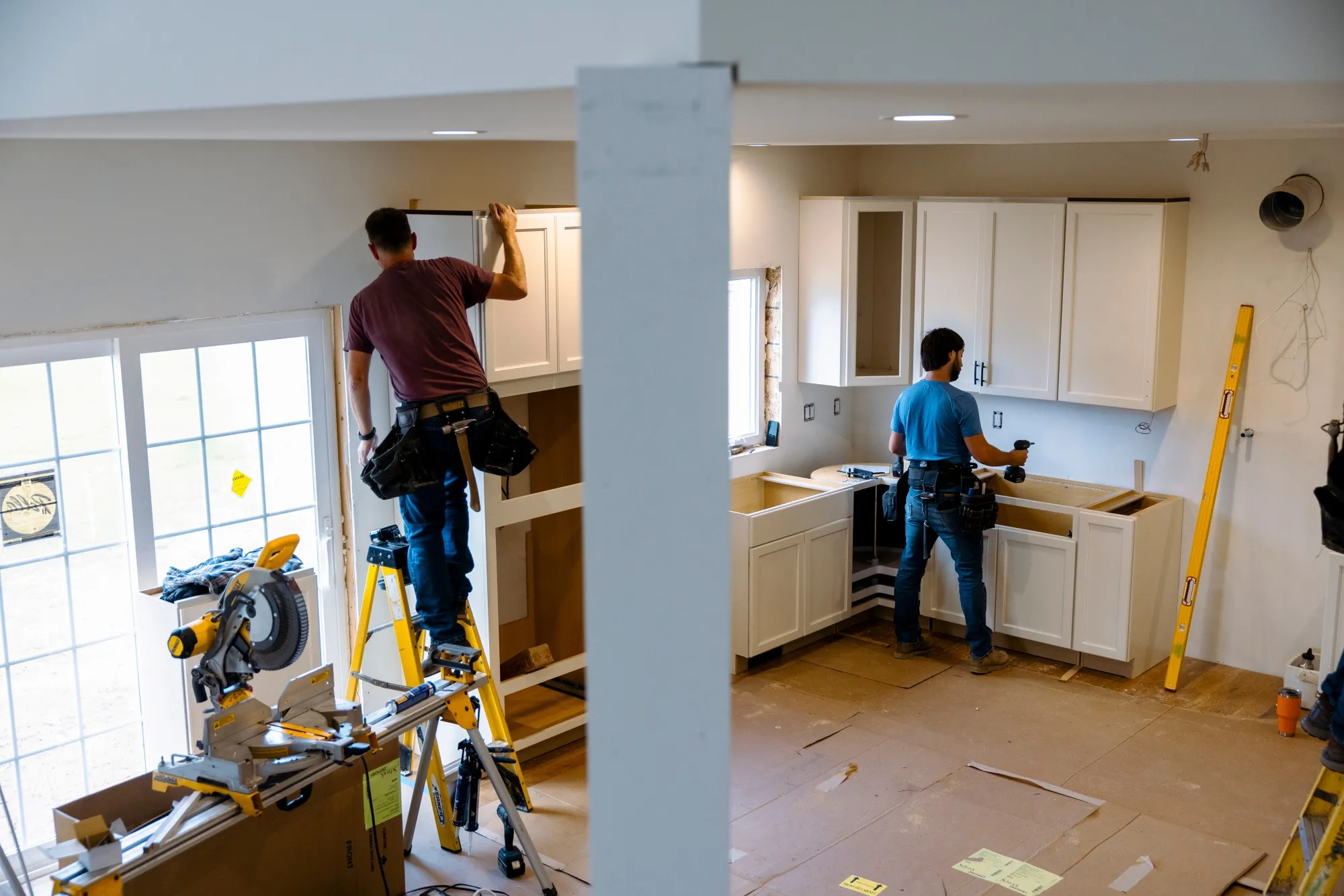 Workers install kitchen cabinets inside a home in Loudonville, New York.