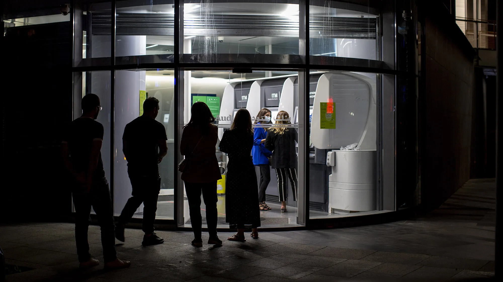 People wait to use ATM machines outside a bank in Beirut, on&nbsp;June 2.&nbsp;