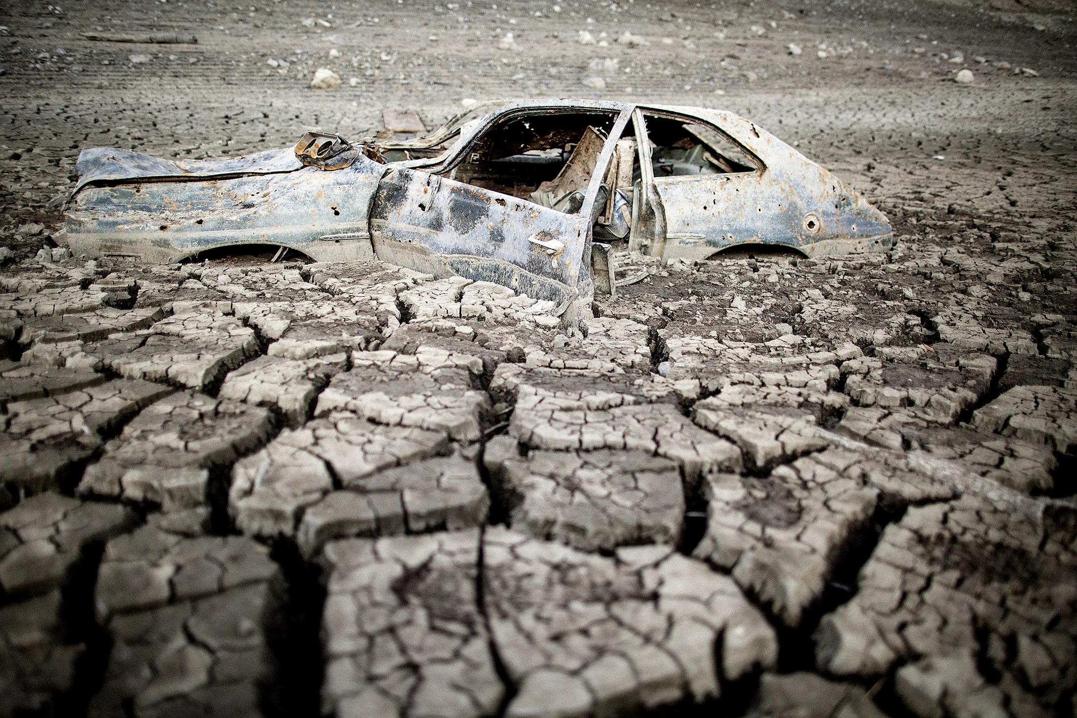 A car is exposed at the bottom of a reservoir, which is is at a record low of 5%, in San Jose, California.
