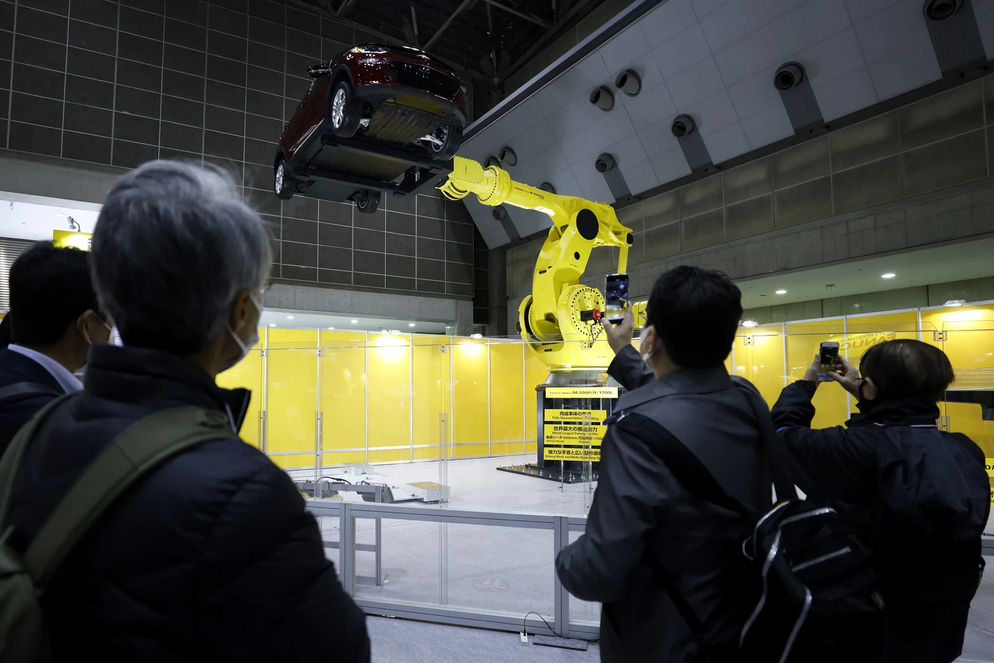 A Fanuc Corp. industrial robot lifts a vehicle during a demonstration at the International Robot Exhibition in Tokyo in March.&nbsp;