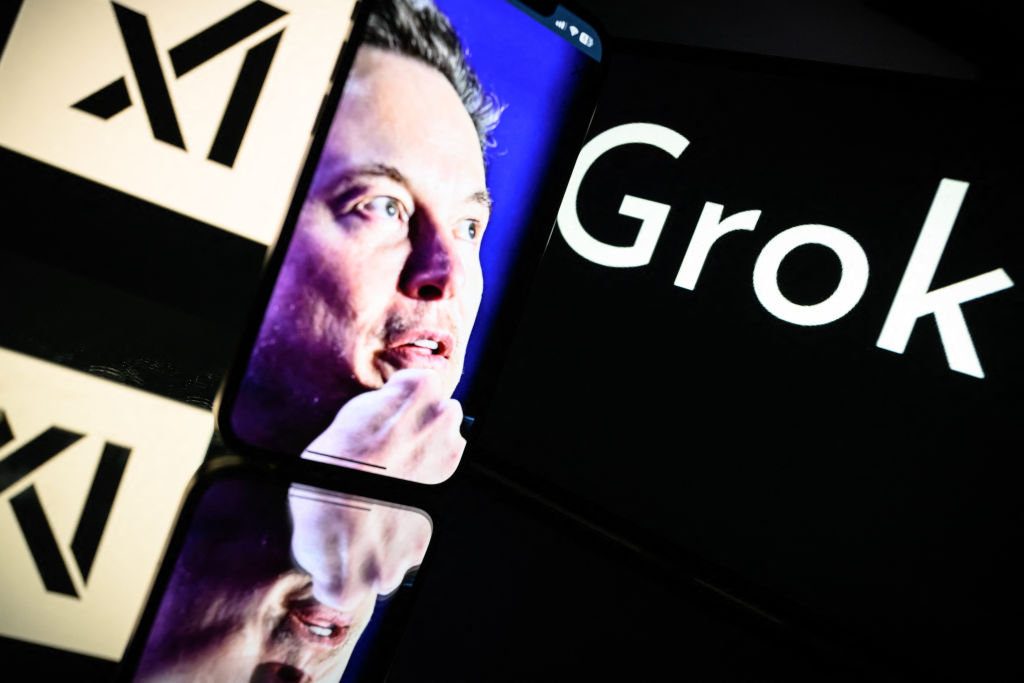 This photograph taken on January 13, 2025 in Toulouse shows screens displaying the logo of Grok, a generative artificial intelligence chatbot developed by xAI, the American company specializing in artificial intelligence and it's founder South African businessman Elon Musk. (Photo by Lionel BONAVENTURE / AFP) (Photo by LIONEL BONAVENTURE/AFP via Getty Images)