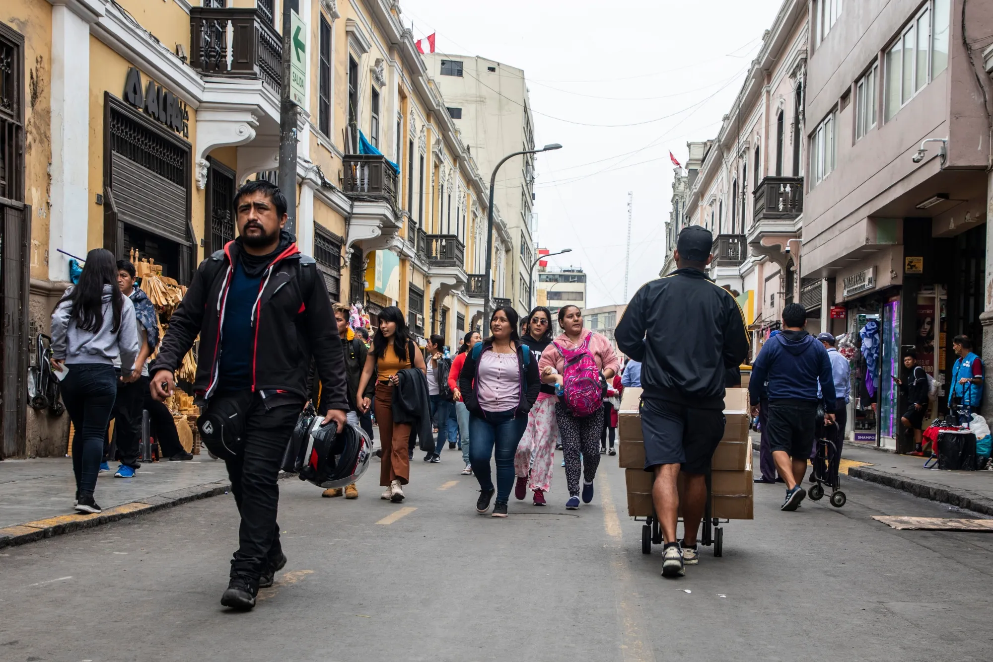 Pedestrians walk through the Mesa Redonda shopping center in Lima, Peru.