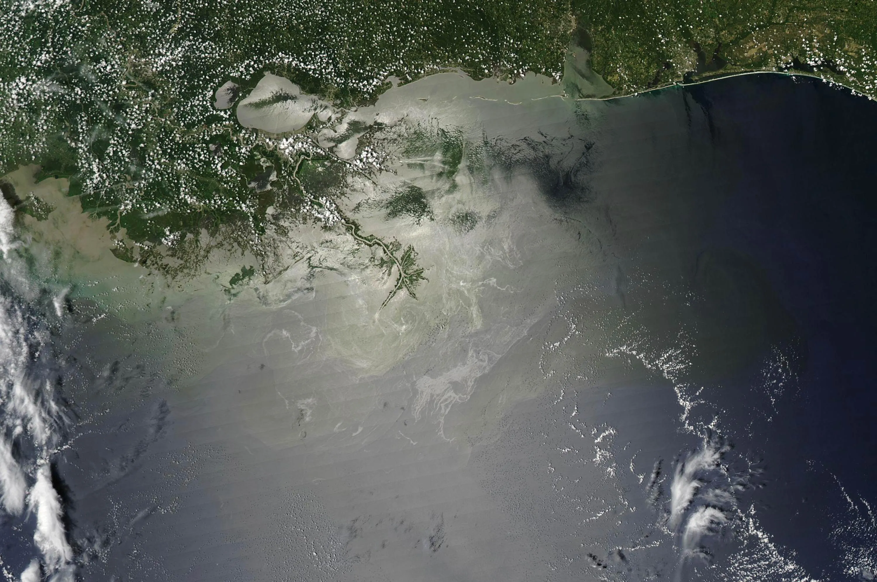 The BP Deepwater Horizon oil spill in the Gulf of Mexico on July 28, 2010. Around the location of the oil leak, and around the Mississippi Delta, relatively light swirls and patches appear on the ocean surface. Photograph: MODIS/NASA via Bloomberg