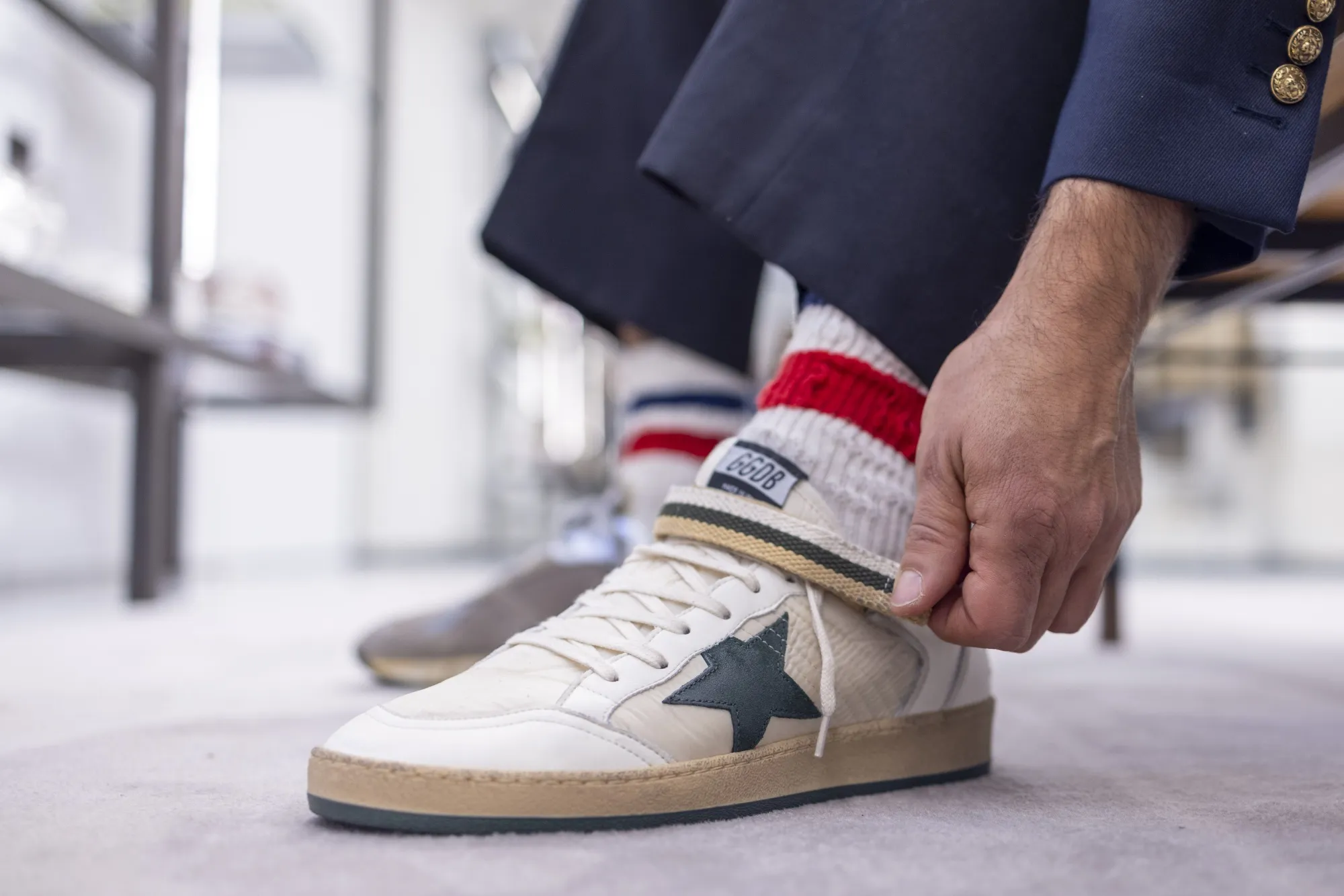 A customer tries on a pair of limited-edition sneakers at a Golden Goose SpA store in the Mayfair district of London.