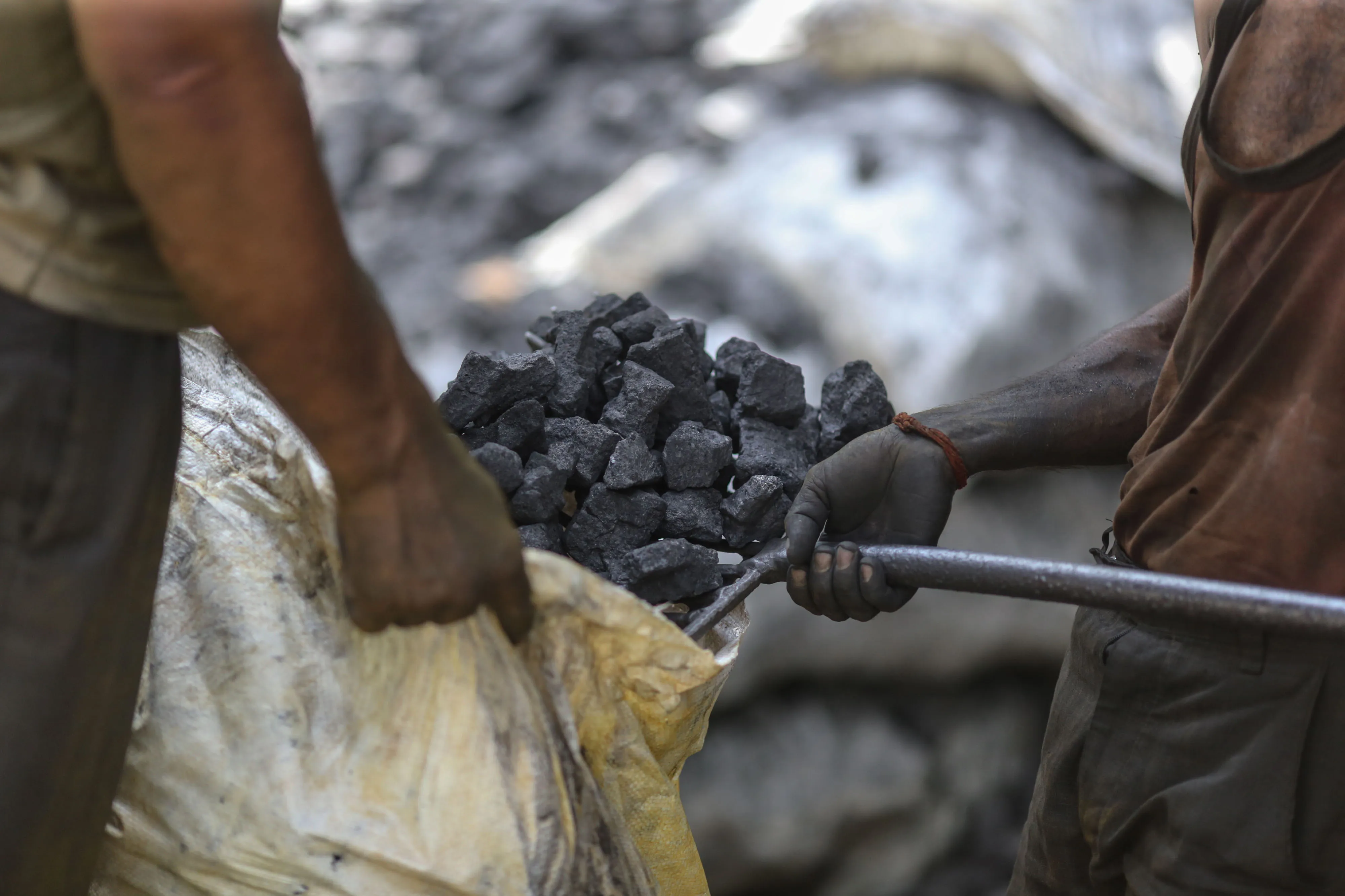 Workers load coal at a wholesale market in Mumbai.