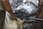 Workers load coal at a wholesale market in Mumbai.