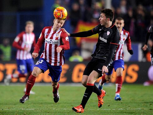 Luciano Vietto of Club Atletico de Madrid heads the ball past Mikel Balenziaga of Athletic Club.
