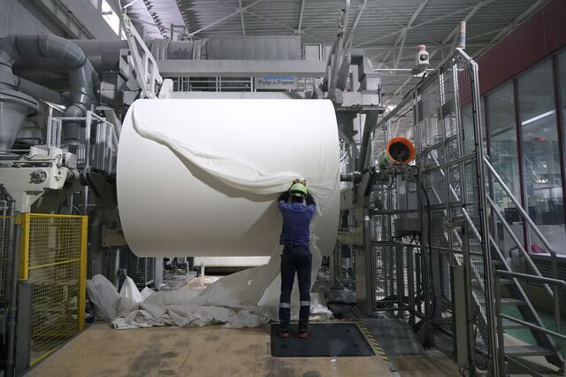 A worker checks a spool of recycled paper on the toilet paper production line at a Corelex Shinei Co. factory in Fuji, Shizuoka Prefecture, Japan, on Tuesday, Sept. 7, 2021. Japan's gross domestic product expanded at an annualized pace of 1.9% in the three months to June, faster than an earlier estimate of 1.3%, according to a revised report by the Cabinet Office on Wednesday. The figures showed extra government spending, business investment and private consumption buoyed growth.