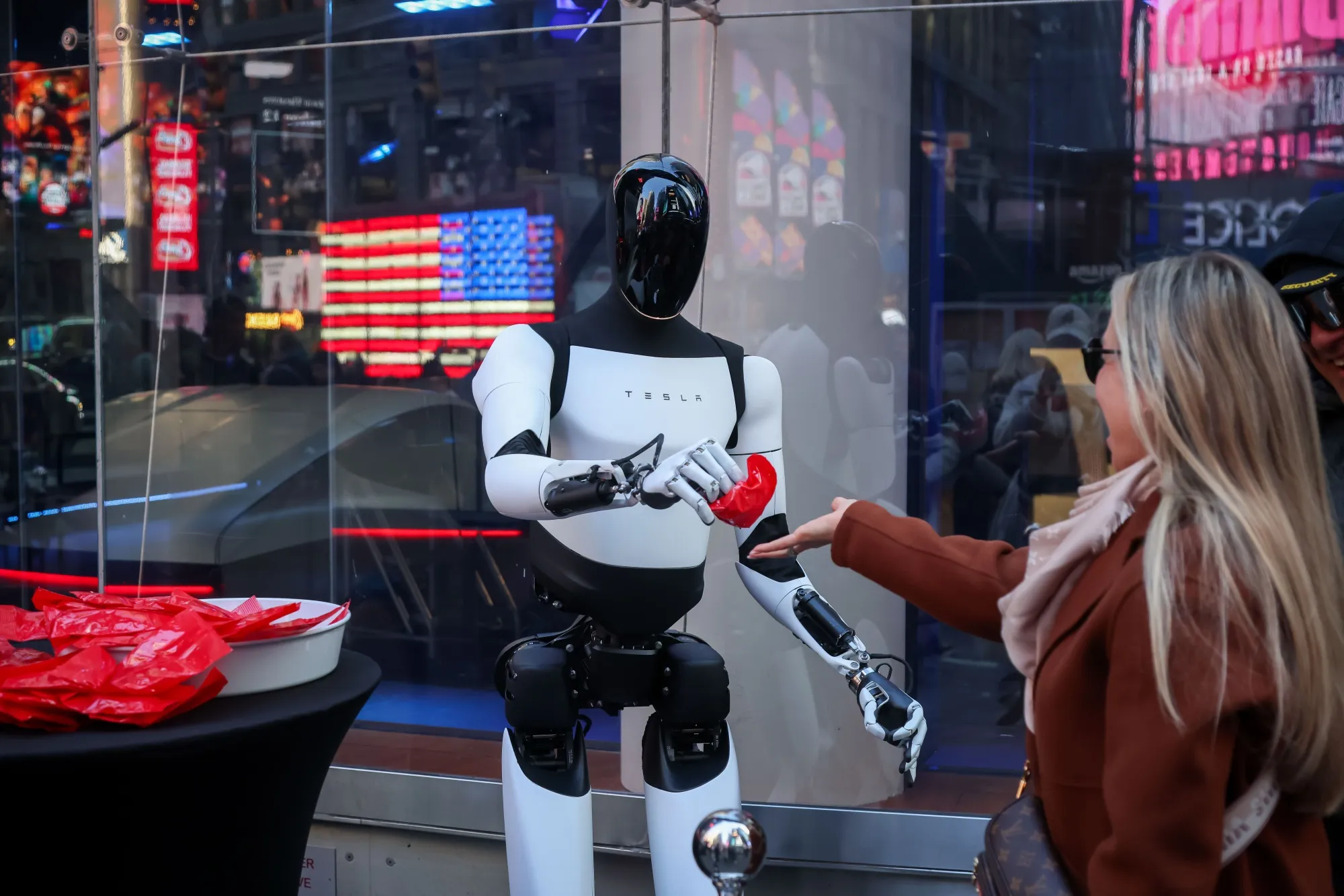 A Tesla Optimus robot hands out candy in front of the Nasdaq MarketSite in New York in October.