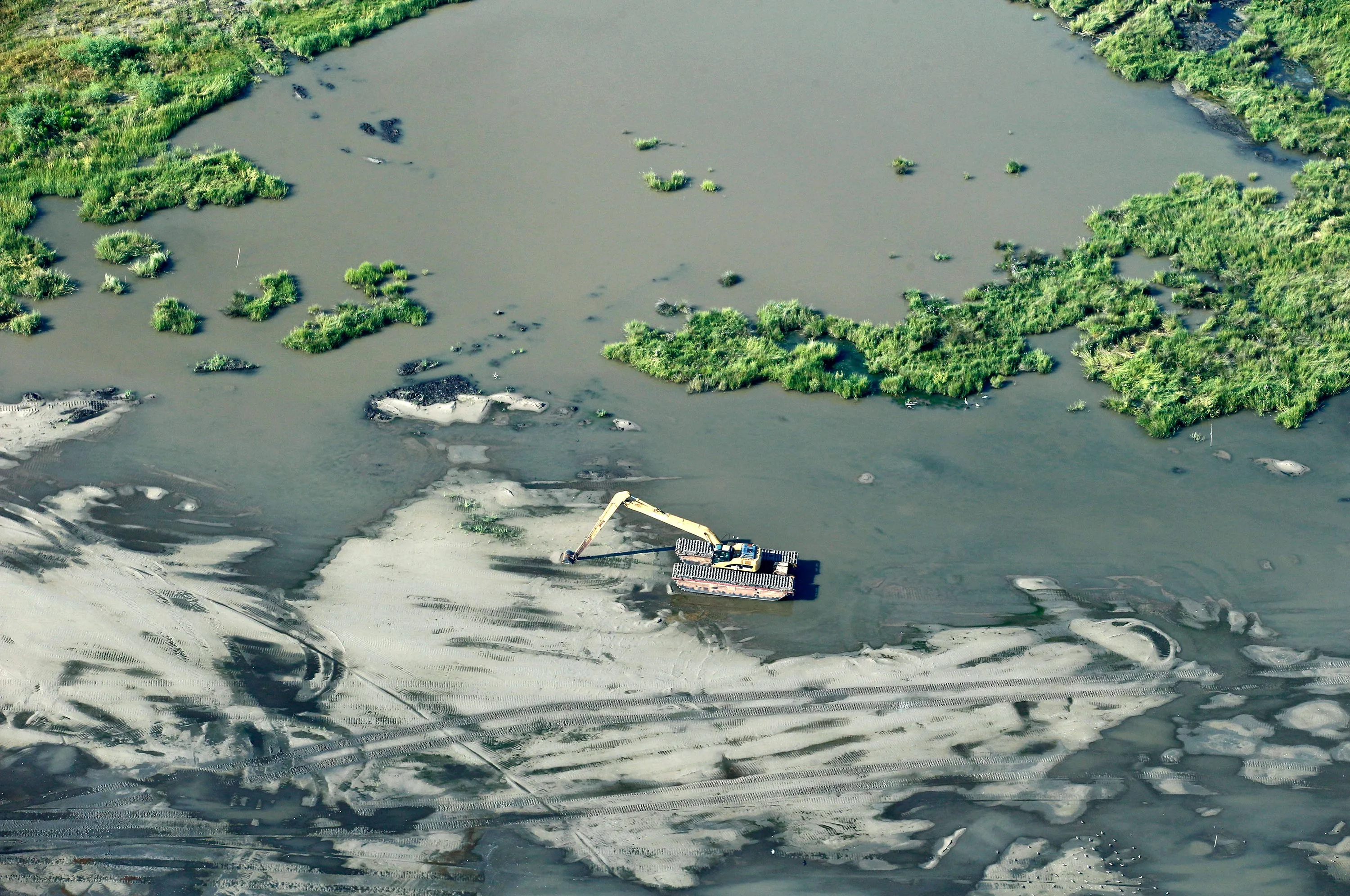 A coastal restoration project in the marsh coast of Louisiana, near the Gulf of Mexico on Sept. 8, 2014. A New Orleans levee board sued 97 oil and gas companies last year, arguing decades of drilling and dredging helped destroy coastal marshes that once shielded the area from flooding. Photographer: Derick E. Hingle/Bloomberg