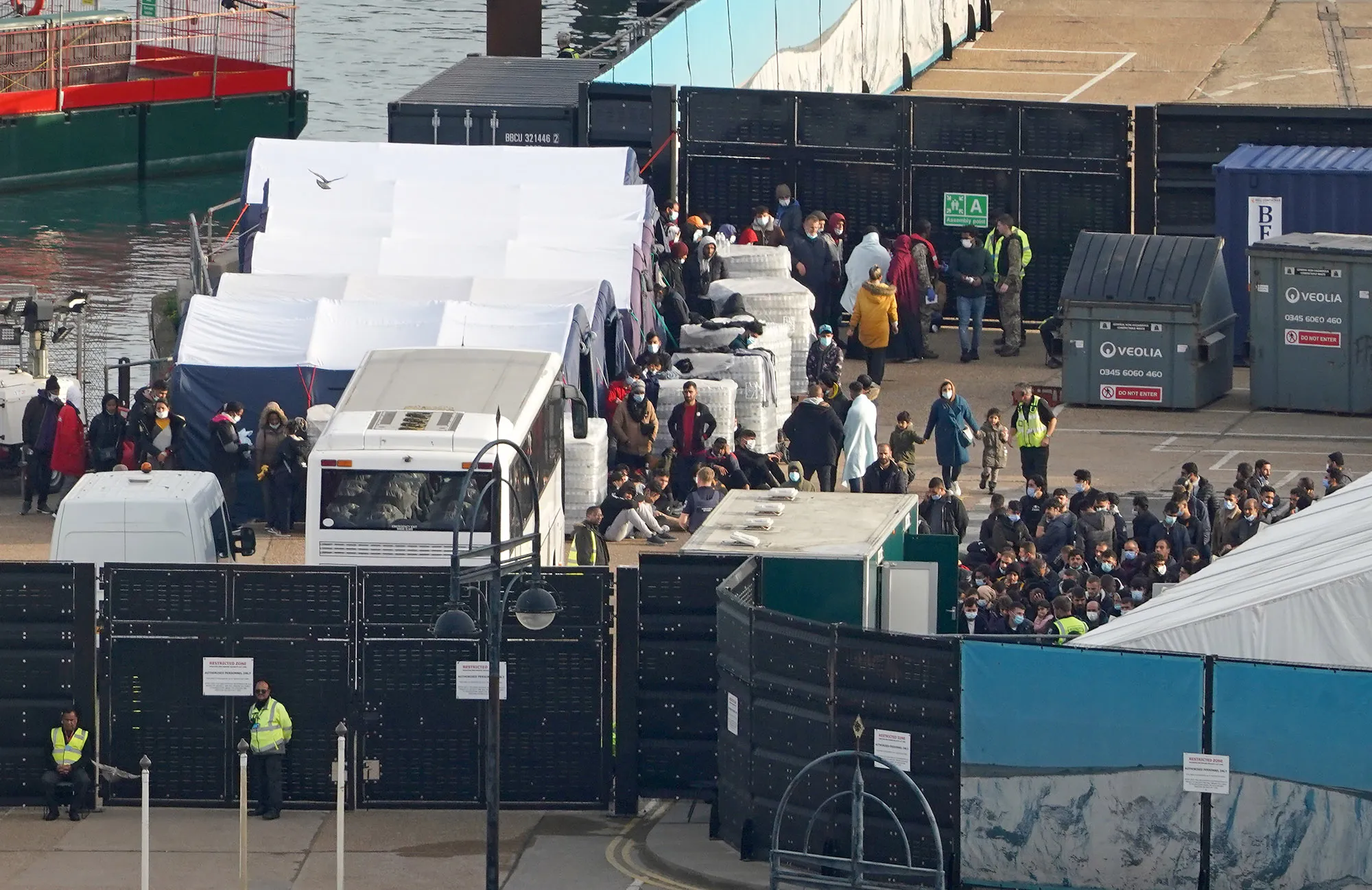 Migrants wait to be processed at the Border Force compound in Dover, on&nbsp;Oct. 29.