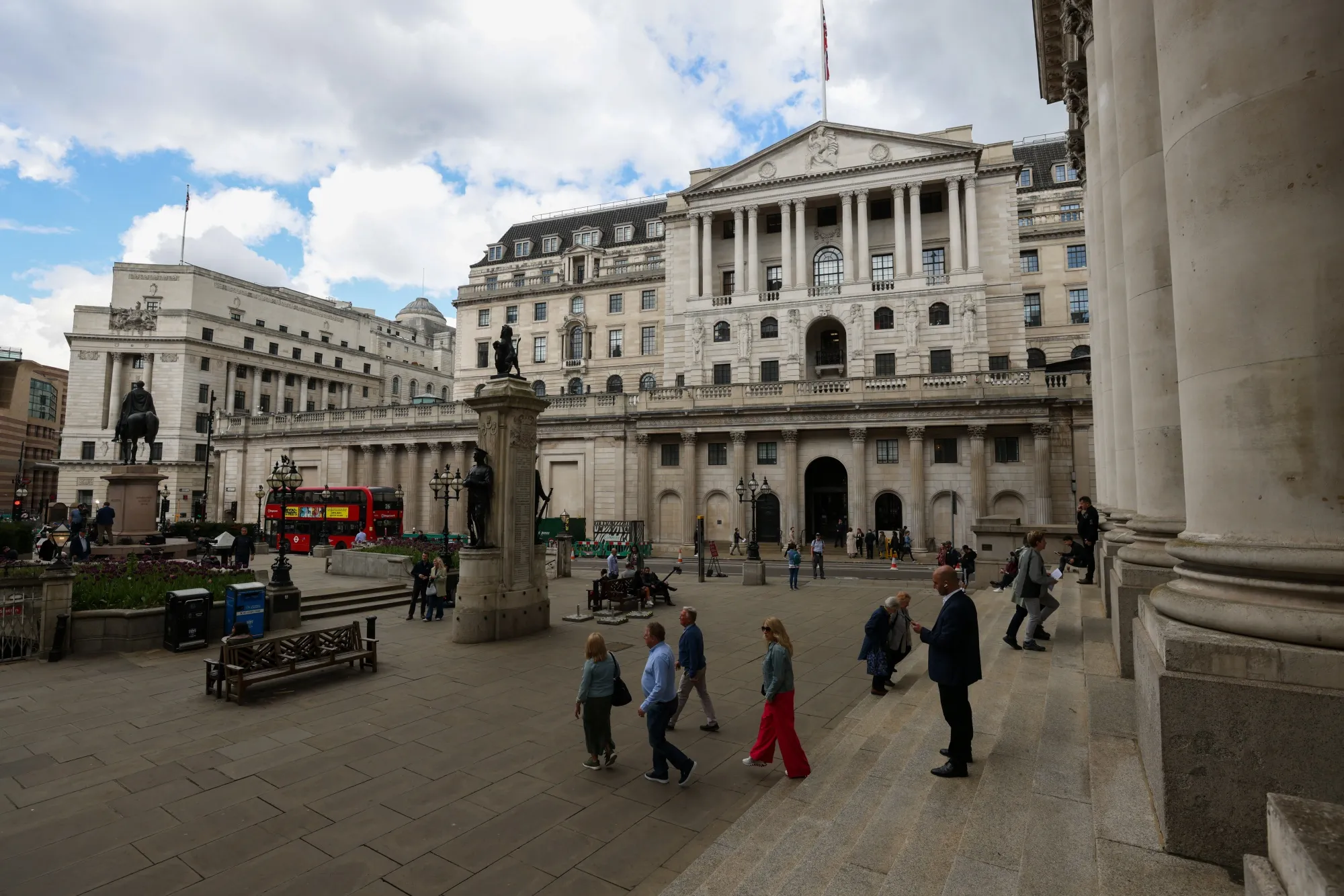Pedestrians pass the Bank of England in London.