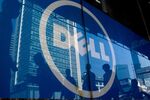 Pedestrians are reflected in a Dell Inc. advertisement in the Tianhe district of Guangzhou.