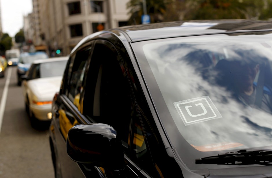 An uber drives through traffic in San Francisco.
