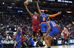 Miami Heat forward Jimmy Butler (22) shoots over New York Knicks guard RJ Barrett (9) during the second half of an NBA basketball game, Wednesday, Jan. 26, 2022, in Miami. The Heat won 110-96. (AP Photo/Lynne Sladky)
