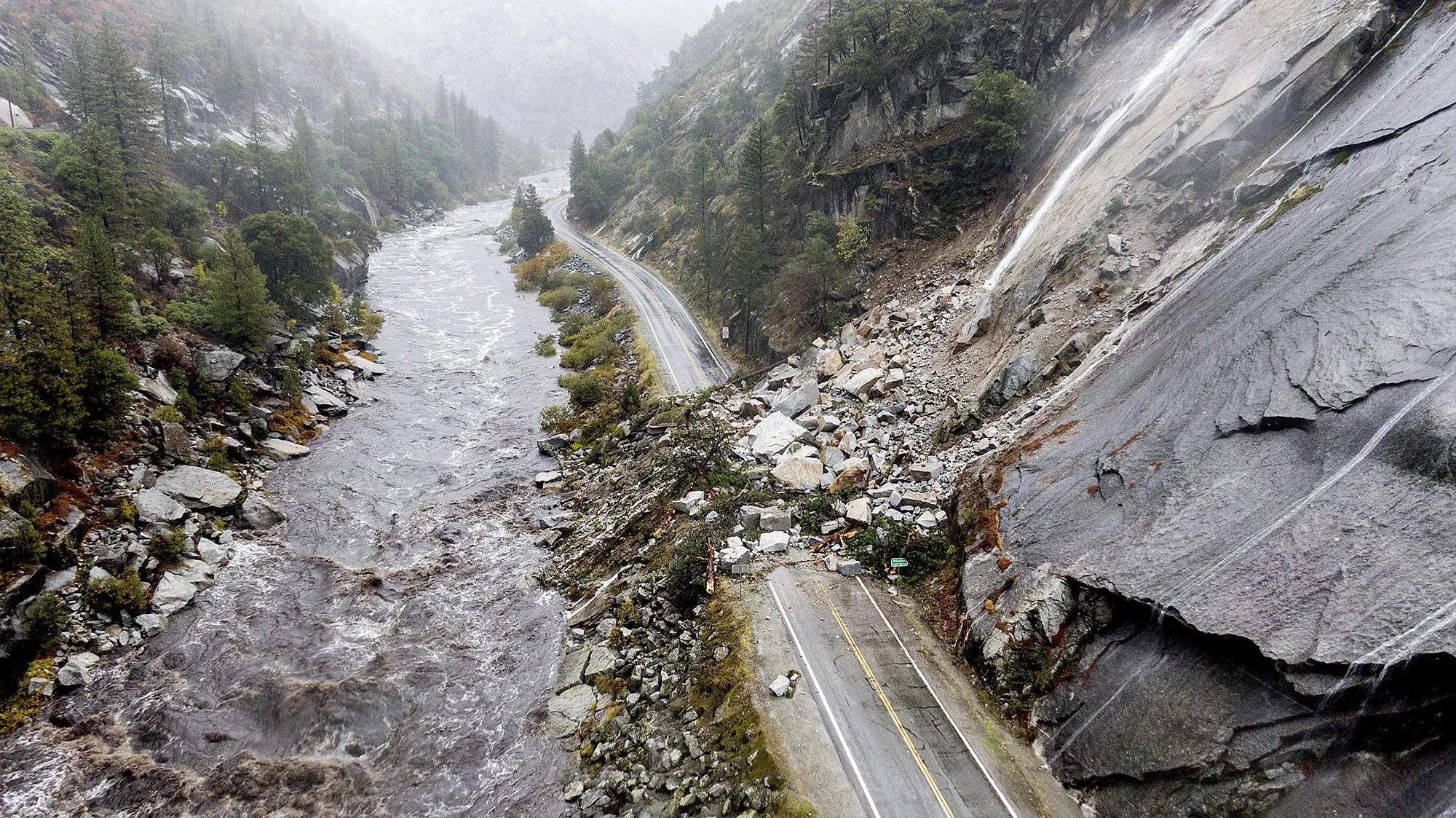 Rocks and vegetation cover Highway 70 following a landslide in the Dixie Fire zone in Plumas County, California on Oct. 24.