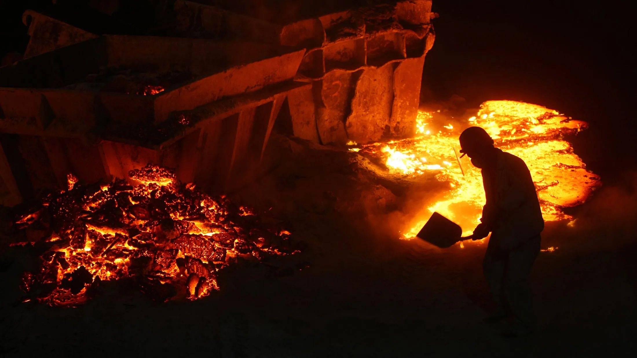 QINGTIAN COUNTY, CHINA - MAY 6: (CHINA OUT) A worker covers the steel slag poured on the ground with sandy soil at a stainless steel factory on May 6, 2008 in Qingtian County of Zhejiang Province, China. According to China Iron and Steel Association, pushed by high demand, domestic steel prices surged by almost 20 percent in the first quarter. Since more steel products are required for China's rapid urbanization and booming real estate industry, the gap between demand and supply will most likely be further widened.
