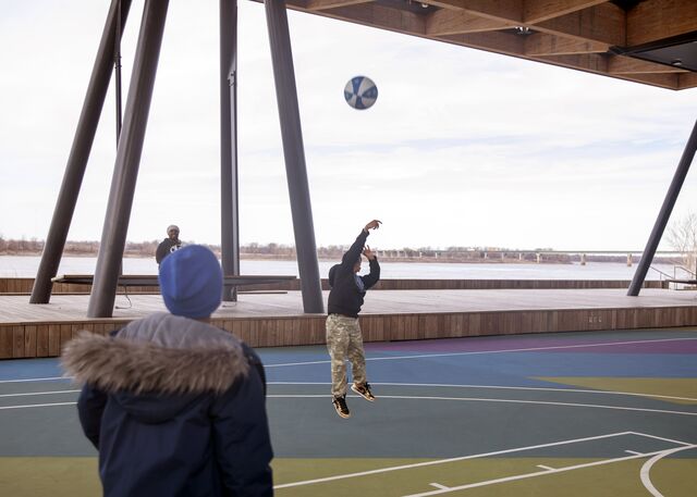 Children play on the basketball courts under the 'Sunset Canopy.'