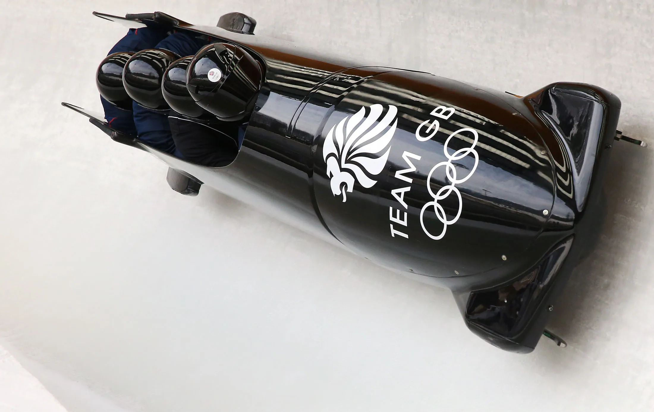 Great Britain team in action during four-man bobsleigh practice at the Sochi 2014 Winter Olympics.
