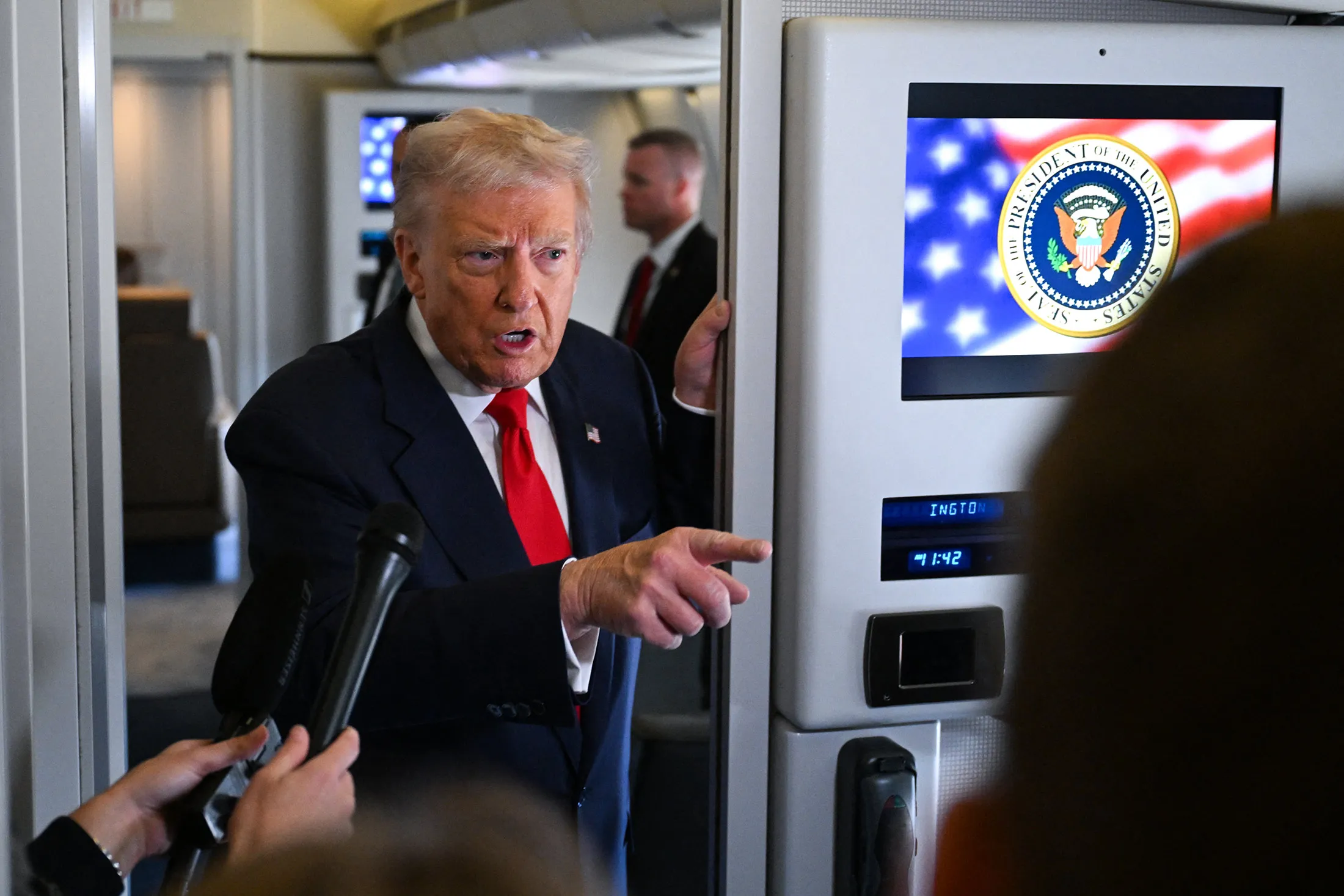 US President Donald Trump speaks to members of the media on Air Force One at Joint Base Andrews, Maryland, on Oct. 31.