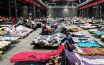 Refugees from Ukraine at the Humanitarian Aid Center set up at the Global Expo exhibition hall in Warsaw, Poland. 