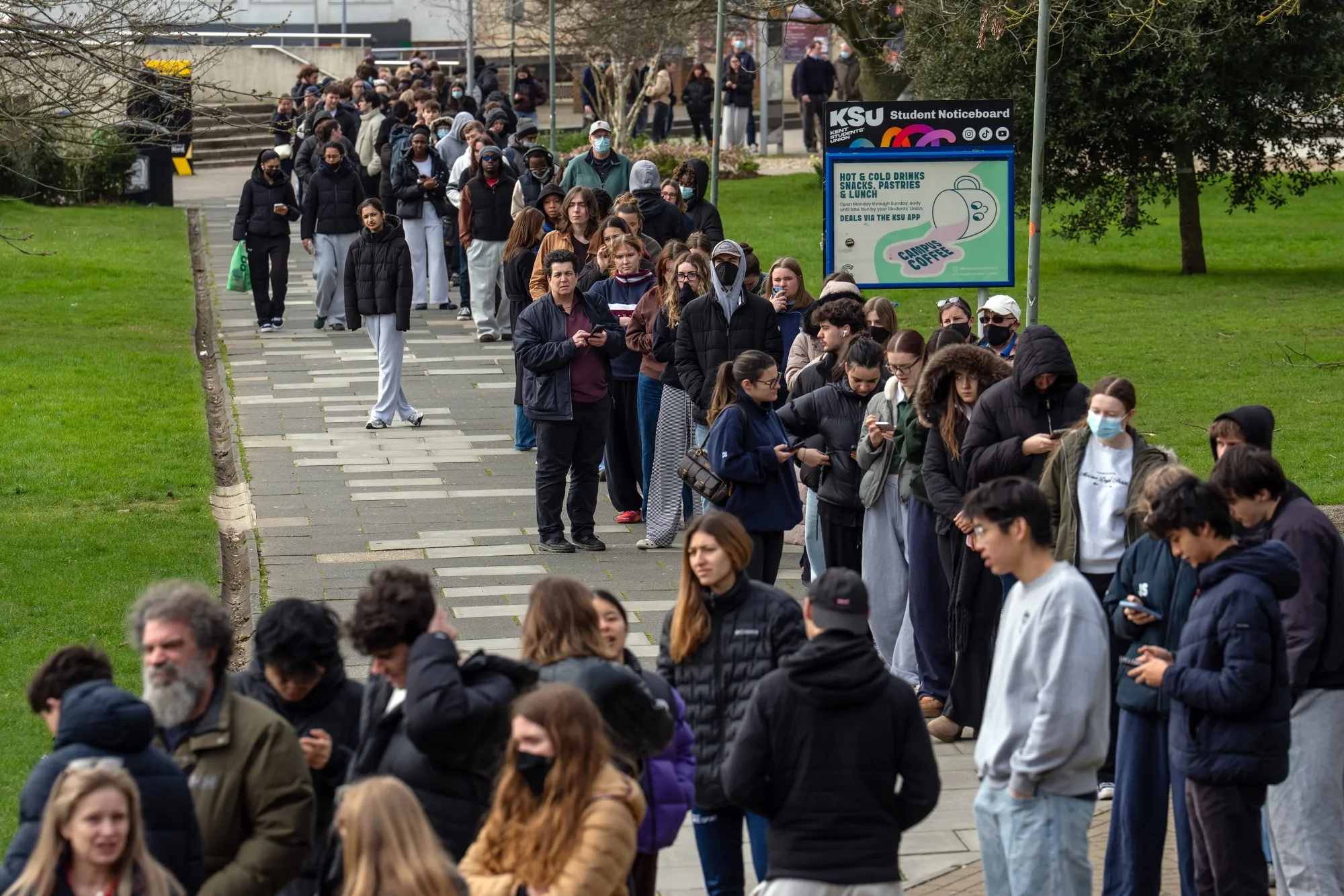 Staff and students&nbsp;queue to receive antibiotics at the University of Kent in Canterbury after an outbreak of meningitis, on March 16.