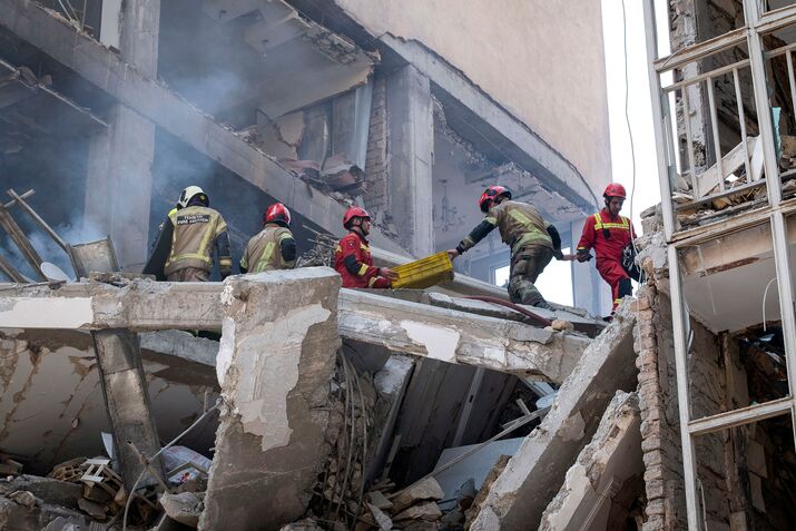 Firefighters at the scene of a destroyed residential building in Tehran on June 13.