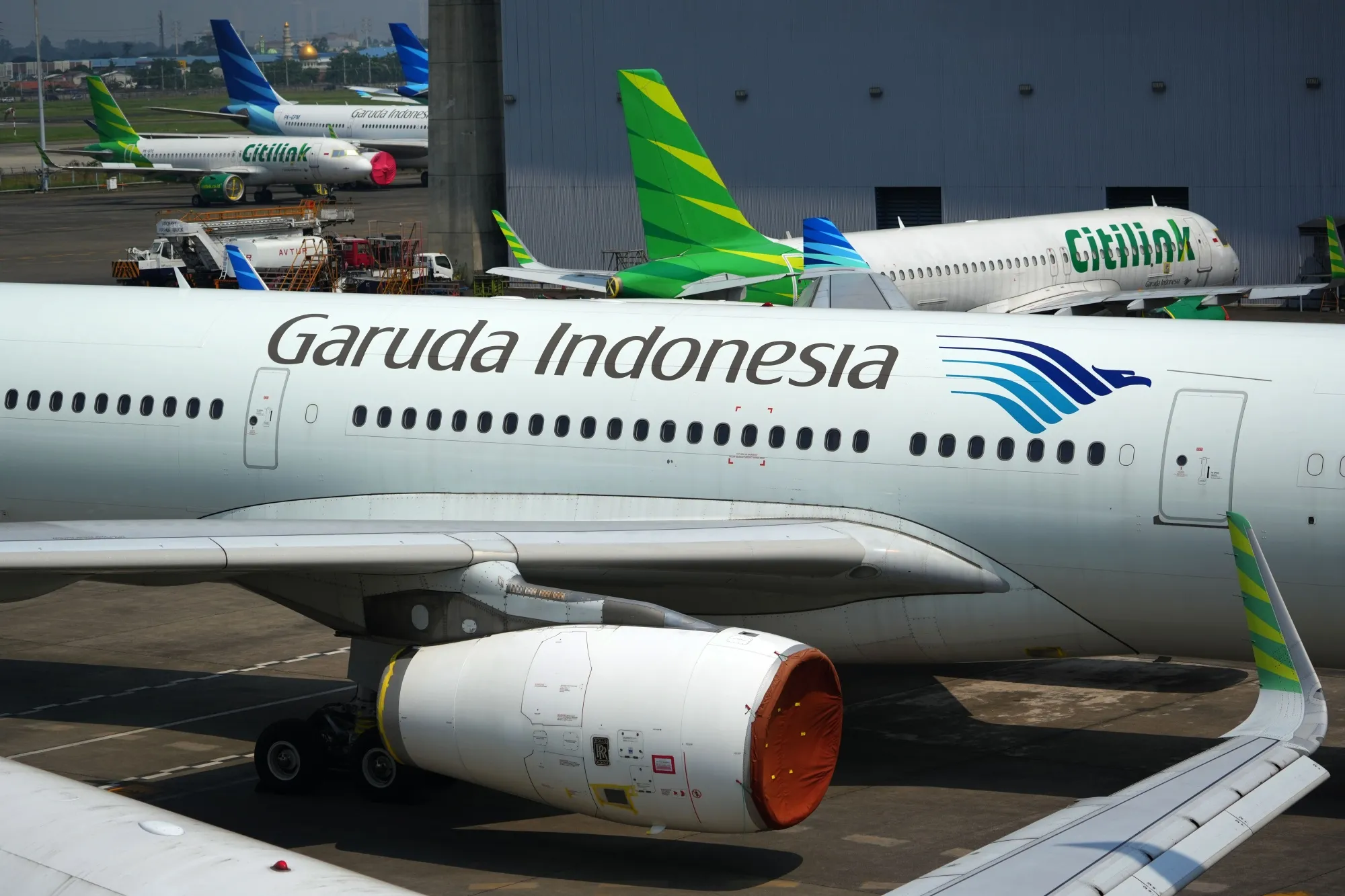 Garuda Indonesia aircraft outside a hangar at Soekarno-Hatta International Airport.