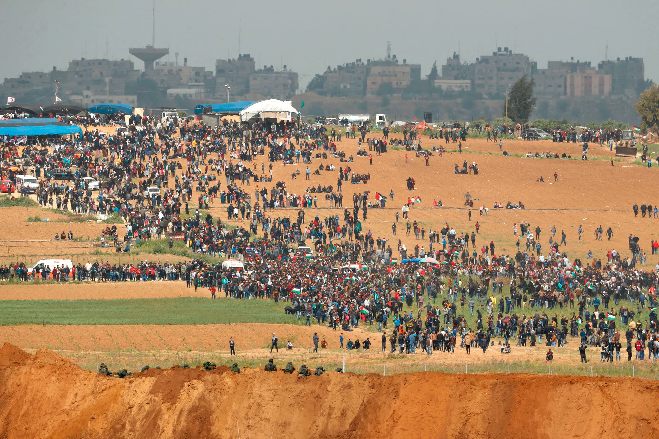 A view from across the border from the Gaza strip shows Palestinians participating in a tent city protest on March 30.&nbsp;