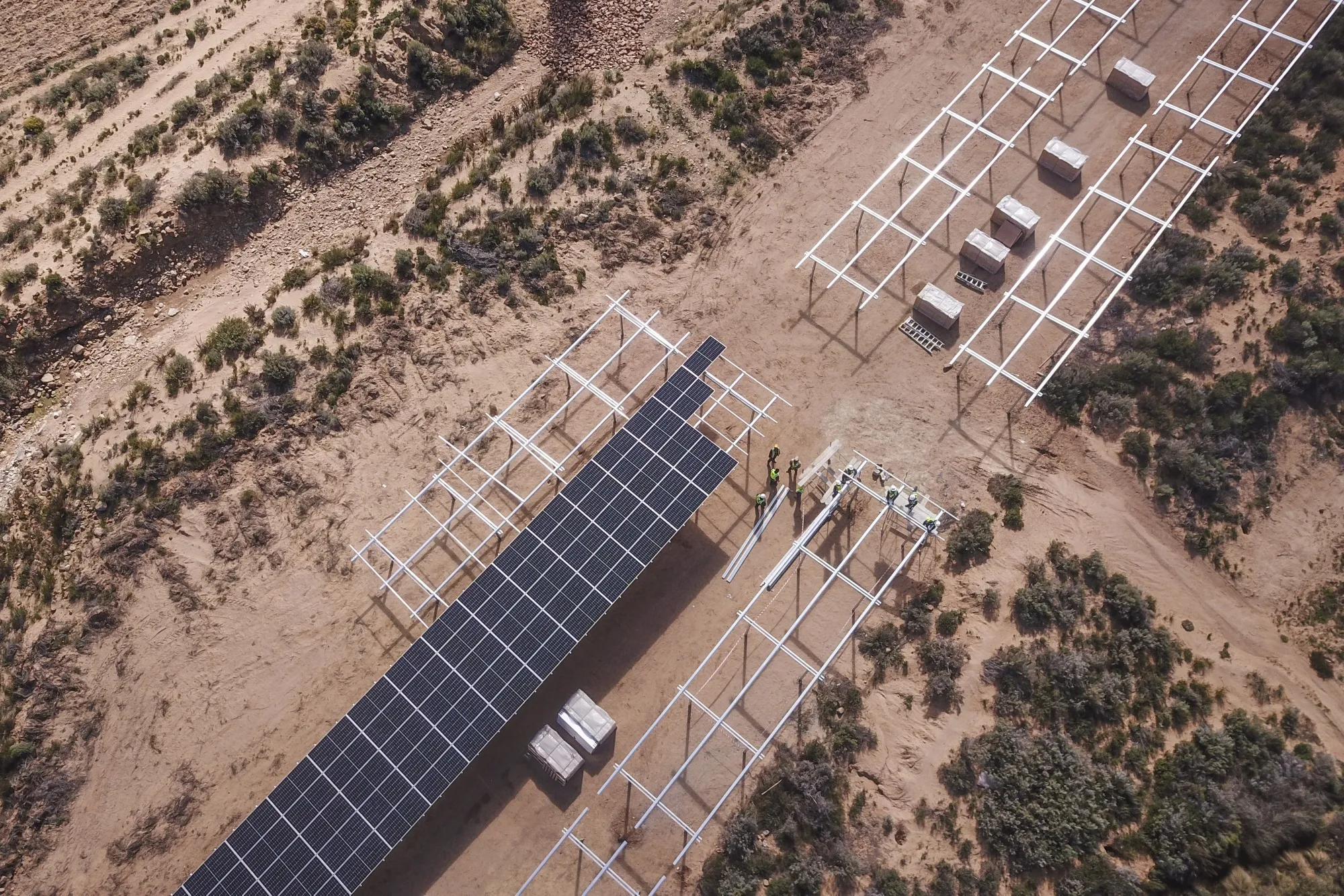 Workers install solar panels at a farm in Groenfontein, South Africa.