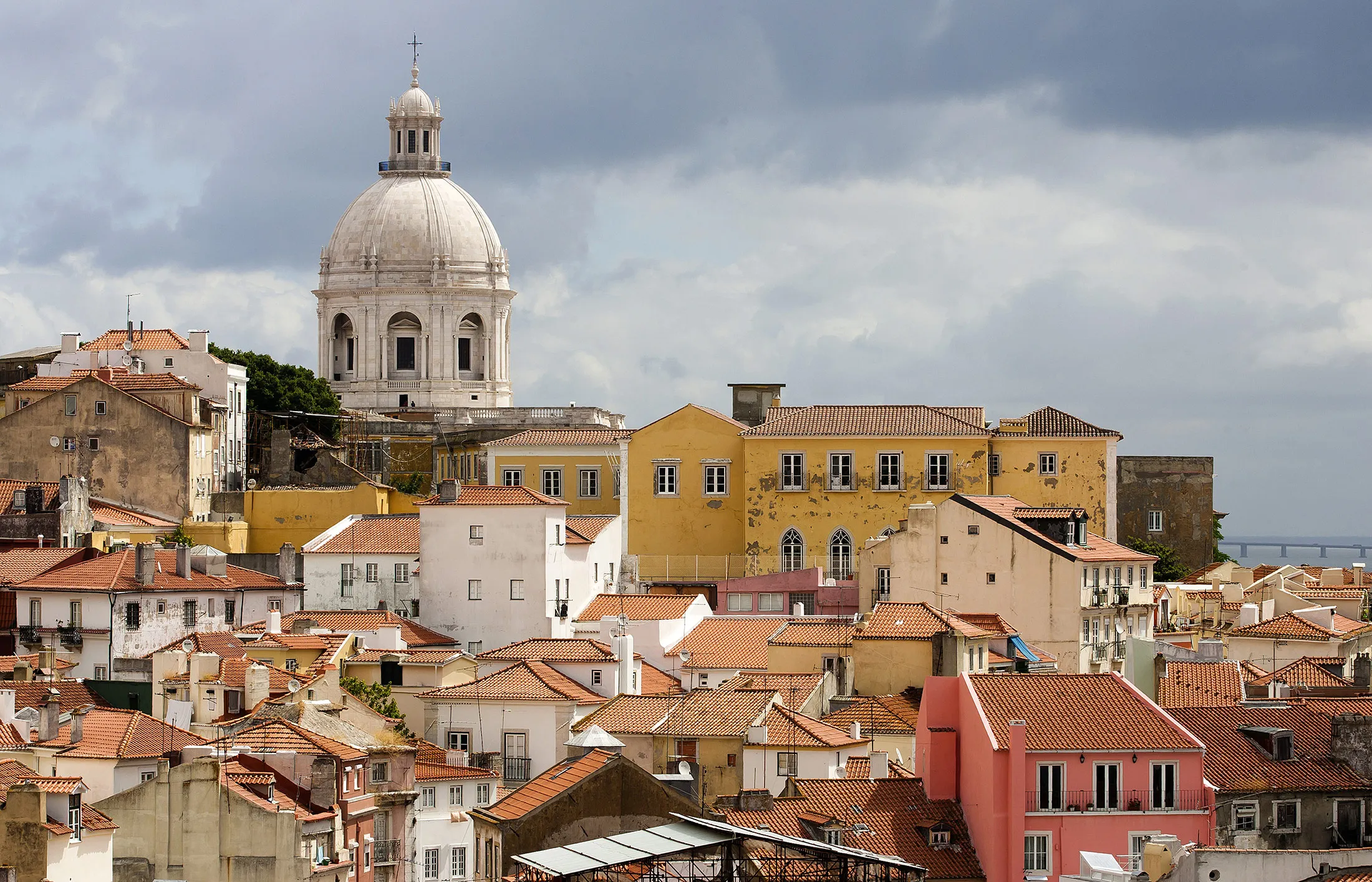 The dome of Santa Engracia church is seen on the horizon beyond residential properties in the old district of Alfama in Lisbon, Portugal, on Tuesday, June 18, 2013. Portugal's borrowing costs increased at an auction of 1.05 billion euros ($1.41 billion) of 18-month bills.