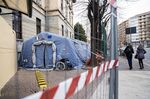 Pedestrians walk past a pre-triage tent outside the Mauriziano Hospital in Turin, Italy.