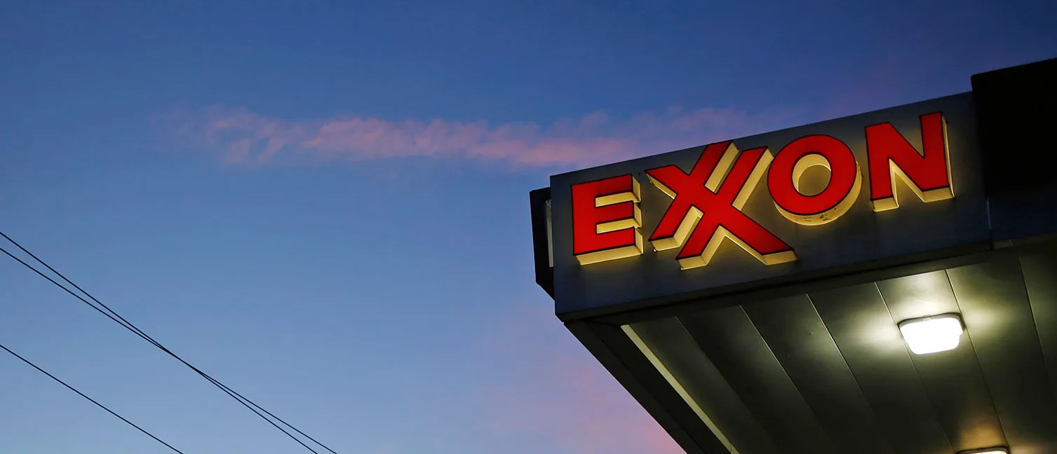 ExxonMobil Corp. signage glows at a gas station in Richmond, Kentucky, U.S. at dawn on Wednesday, April 29, 2015. Photographer : Luke Sharrett / Bloomberg
