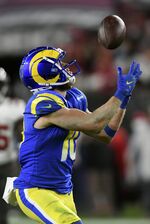 Los Angeles Rams wide receiver Cooper Kupp (10) pulls in a pass from quarterback Matthew Stafford during the second half of an NFL divisional round playoff football game against the Tampa Bay Buccaneers Sunday, Jan. 23, 2022, in Tampa, Fla. (AP Photo/Jason Behnken)