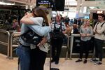 People embrace as they are reunited at Auckland International Airport on April 19.