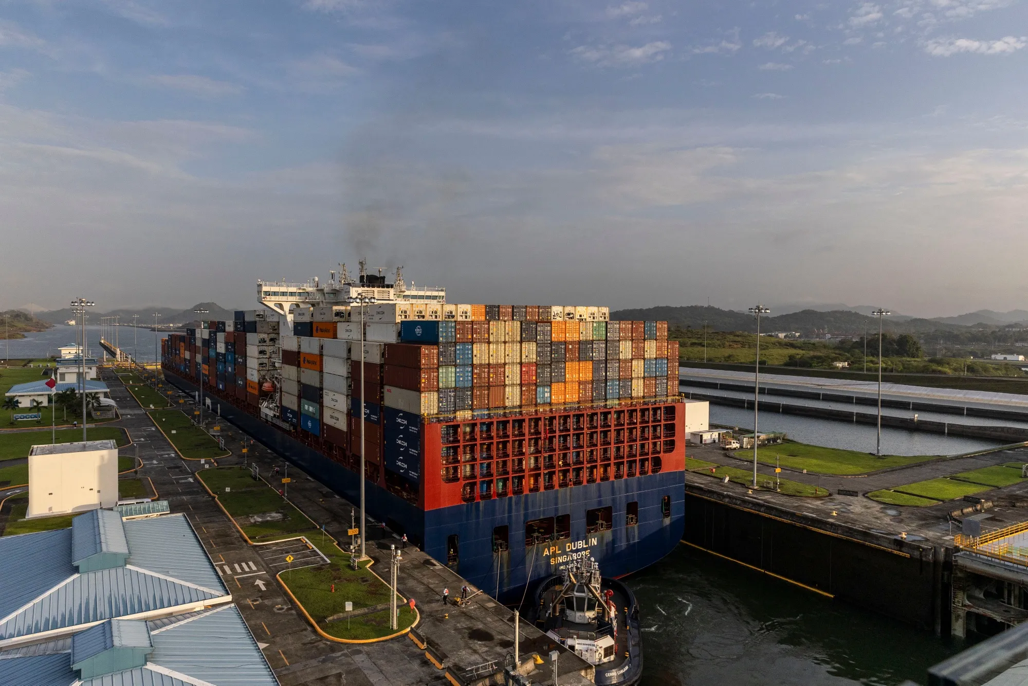 A tug guides a container ship through the Cocoli Locks at the Panama Canal in Panama City, Panama, on Feb. 21.