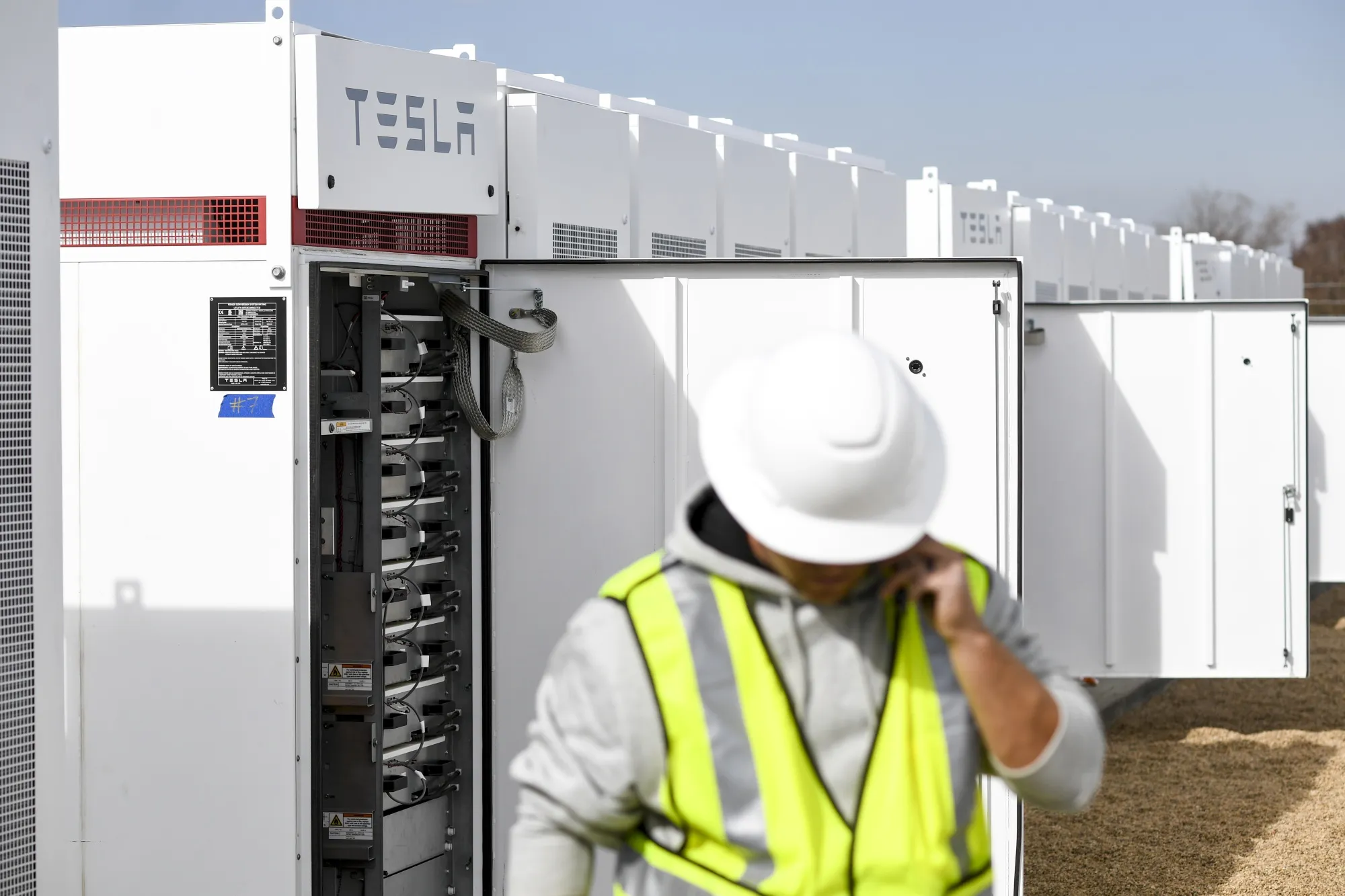 A technician&nbsp;installs&nbsp;Tesla batteries at a energy storage facility near Longmont, Colo.