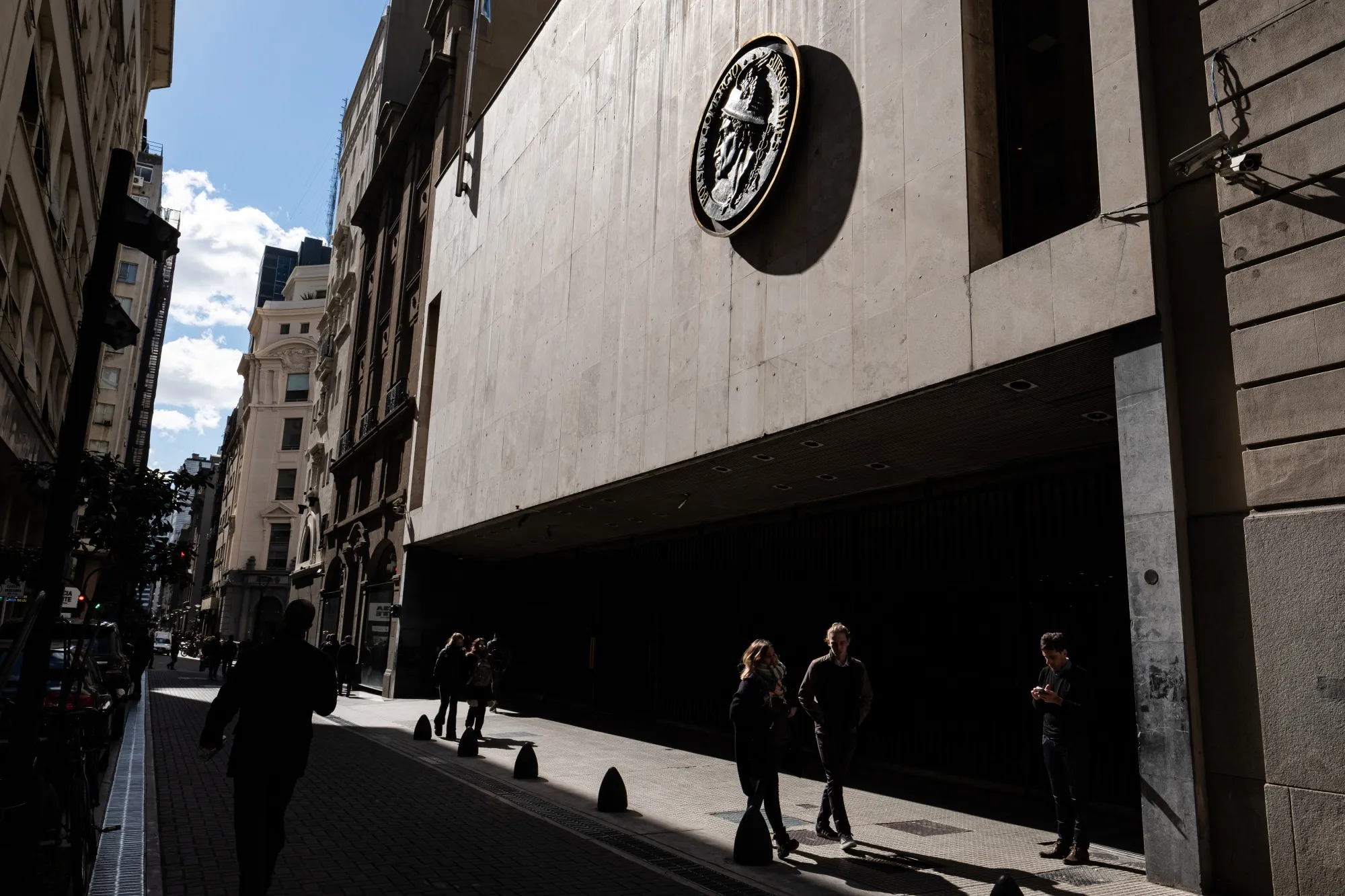 Pedestrians walk past the Buenos Aires Stock Exchange&nbsp;in Buenos Aires, Argentina.