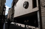 Pedestrians walk past the Buenos Aires Stock Exchange in Buenos Aires, Argentina.