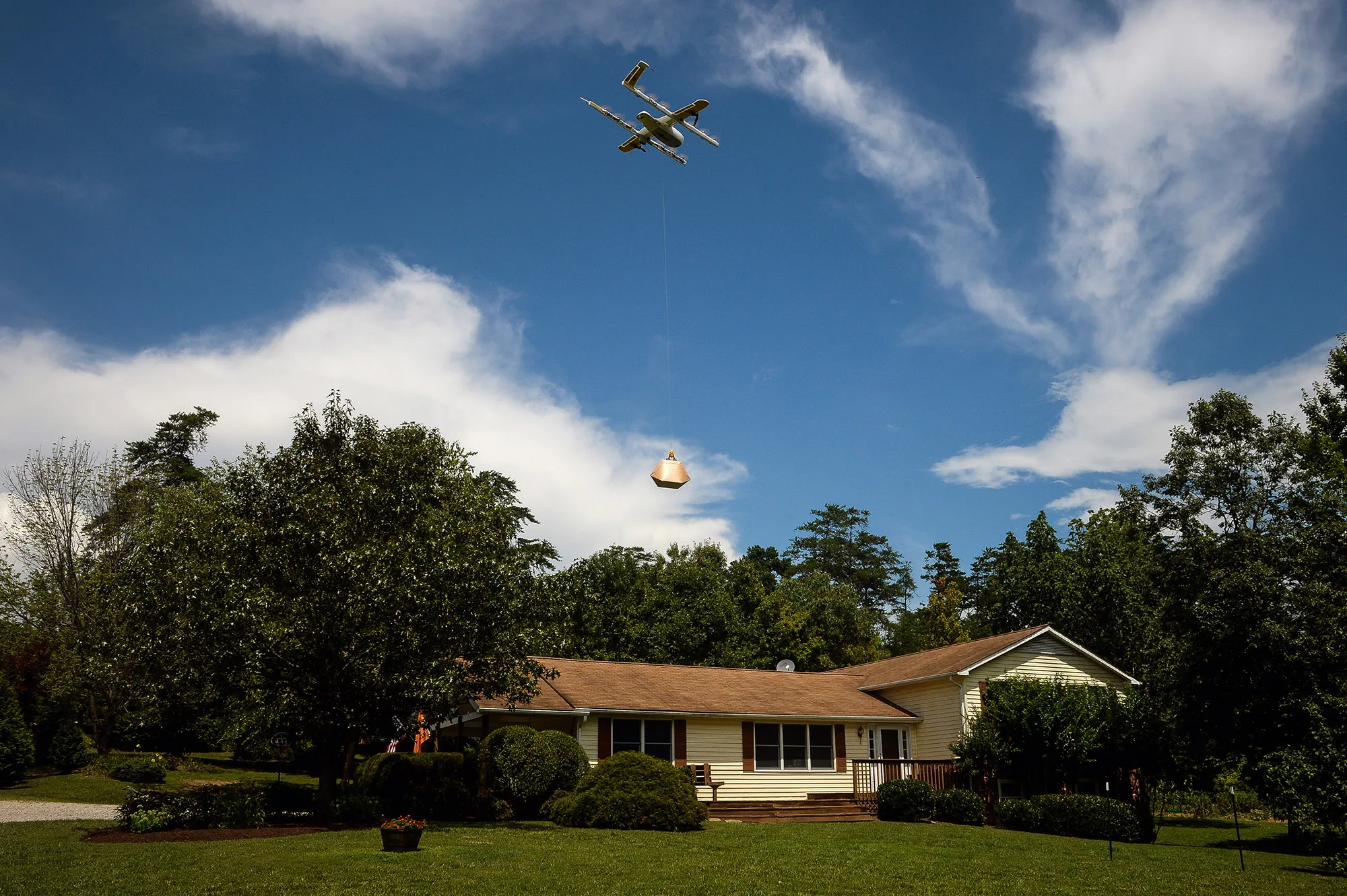 An Alphabet Wing drone delivers a package at a home during a demonstration in Blacksburg, Virginia.