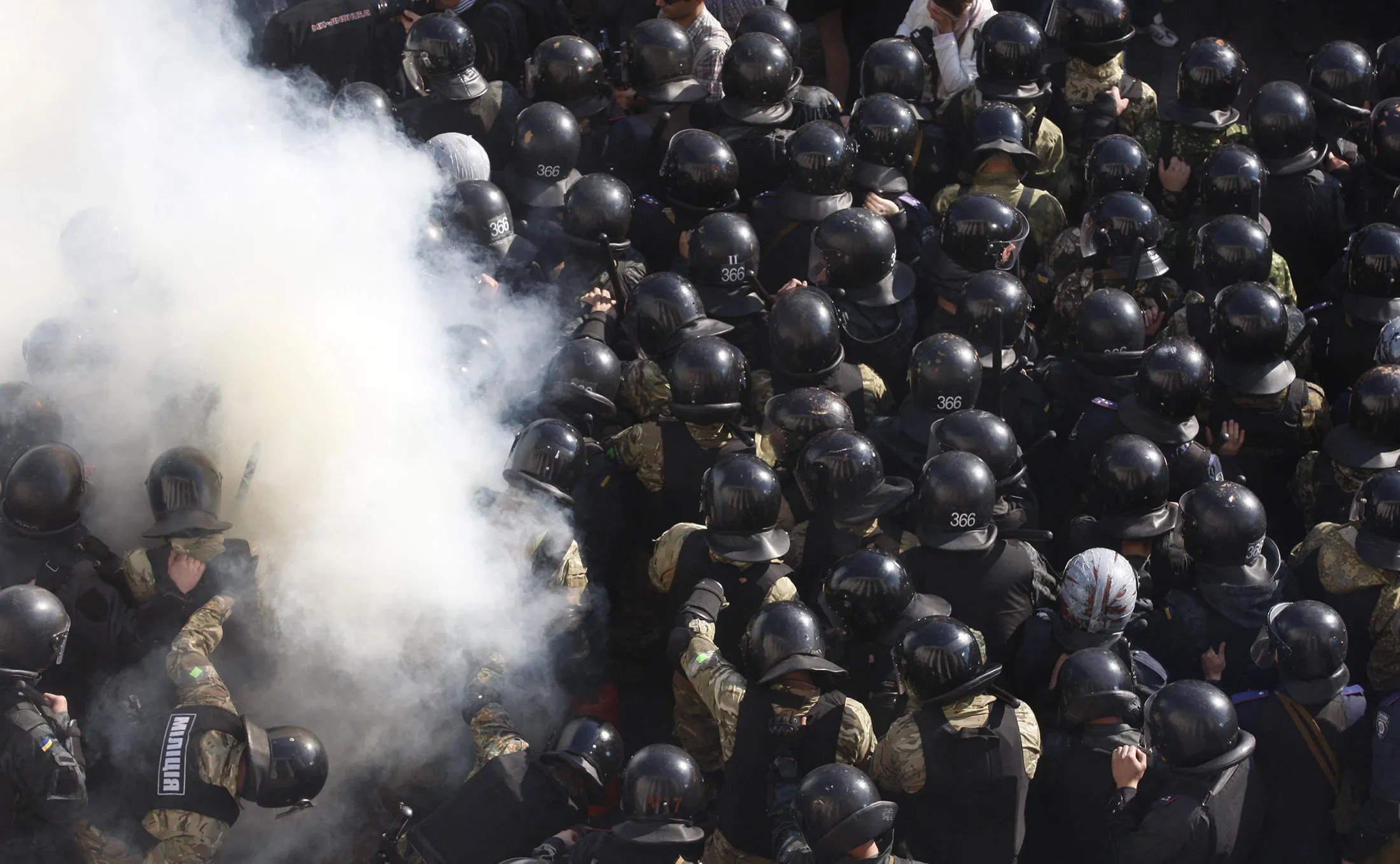 Ukrainian nationalist activists clash with riot police outside the parliament in Kiev on Oct. 14, 2014.
