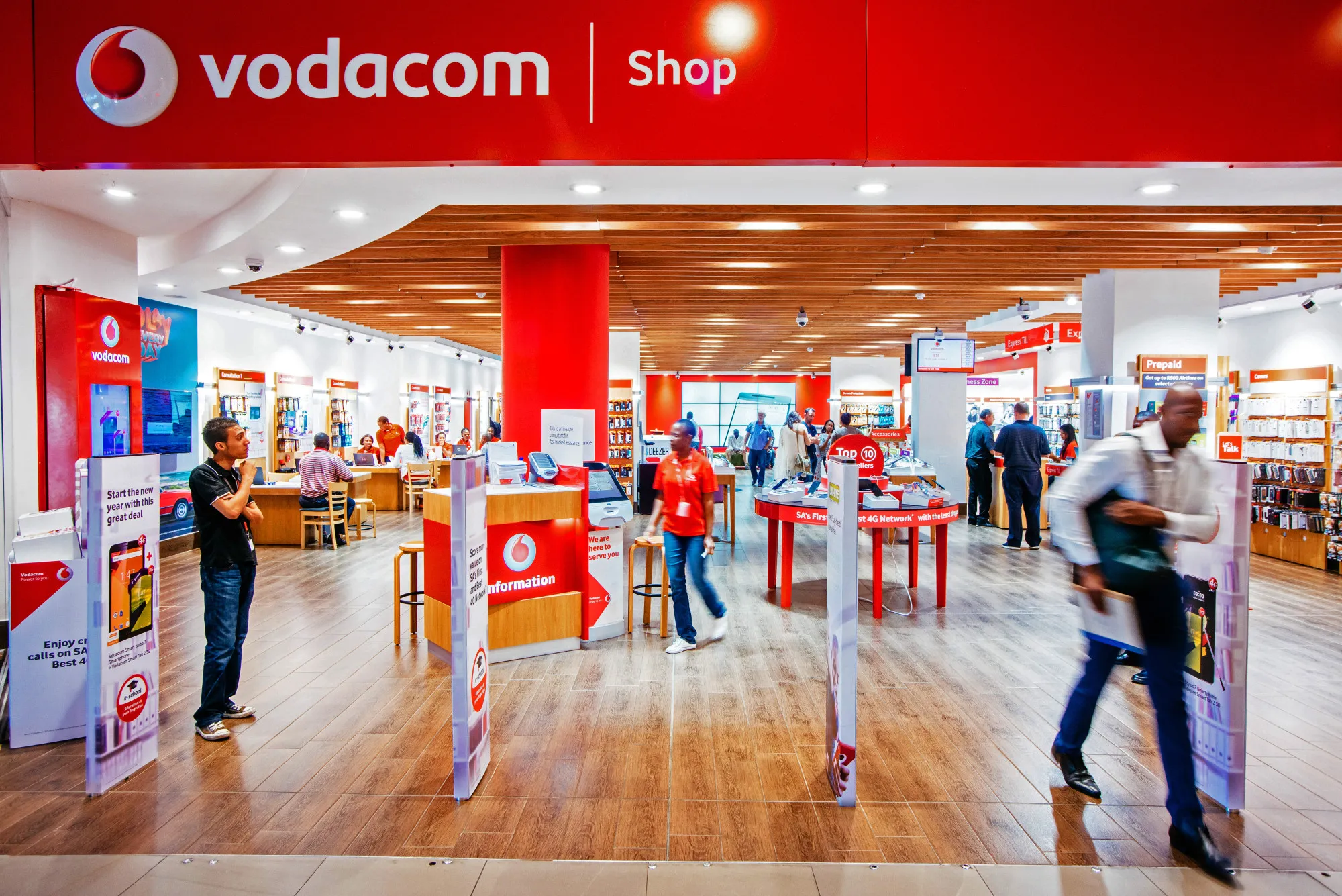 Customers visit a mobile phone store inside the Vodacom World mall in Johannesburg, South Africa.