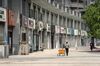 A pedestrian pulls a cart past closed stores on a near-empty street in Wuhan, China, on Friday, May 1, 2020. The lifting on April 8 of the unprecedented lockdown on Wuhan -- where the virus pathogen first emerged -- was a milestone. Stringent nationwide restrictions in China meant the world's second-largest economy recorded its deepest contraction in decades over the first quarter.